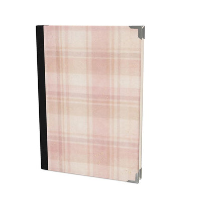 Notebook with a pink and beige plaid pattern on a white background