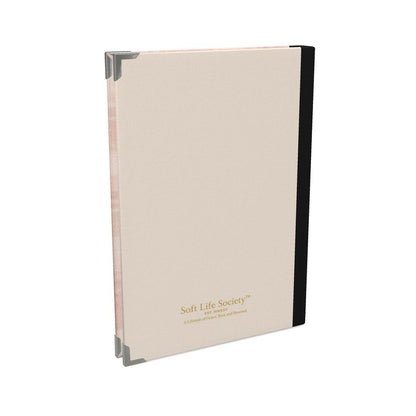 Beige notebook with black binding on a white background