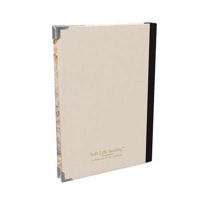 Beige notebook with black binding on a white background, featuring 'Soft Life Society' branding.
