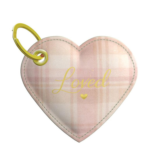 Heart-shaped plaid leather keychain with 'Loved' text and gold heart on a white background