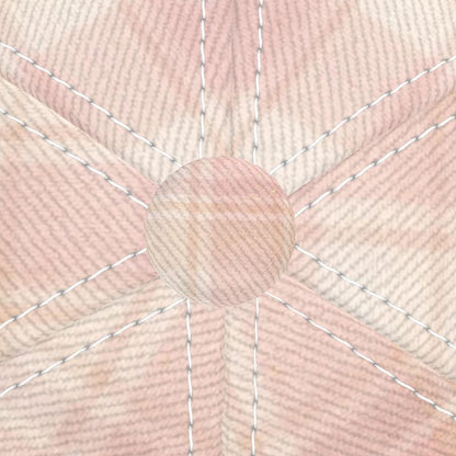 Close-up of a pink fabric with a bow and stitching details