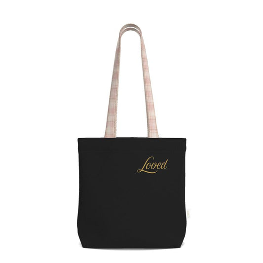 Black tote bag with 'Loved' embroidery on a white background