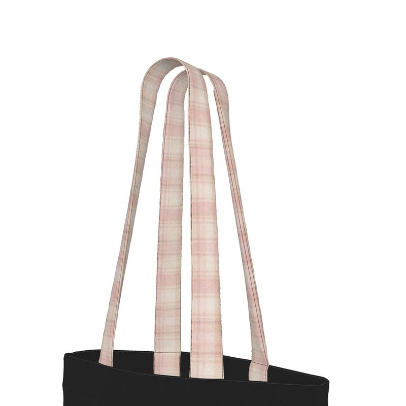 Black tote bag with pink plaid straps on a white background