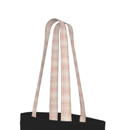Black tote bag with pink plaid straps on a white background