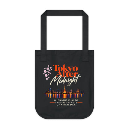 Front view of the Tokyo After Midnight black organic cotton tote featuring title artwork, cherry blossoms, Tokyo skyline, and reader quote.