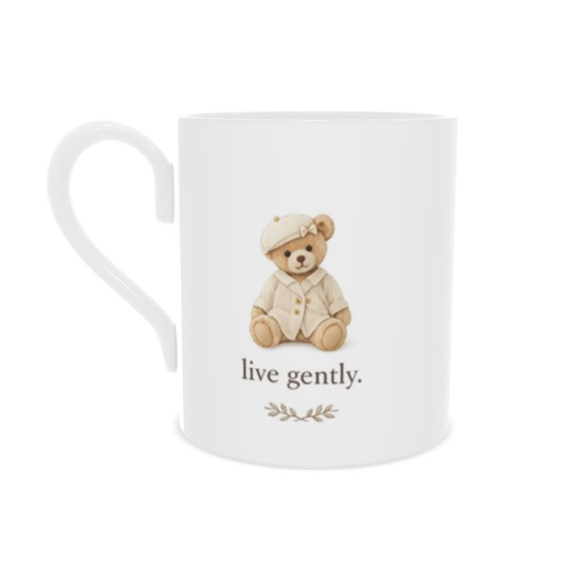 White mug with a teddy bear illustration and 'live gently' text on a white background