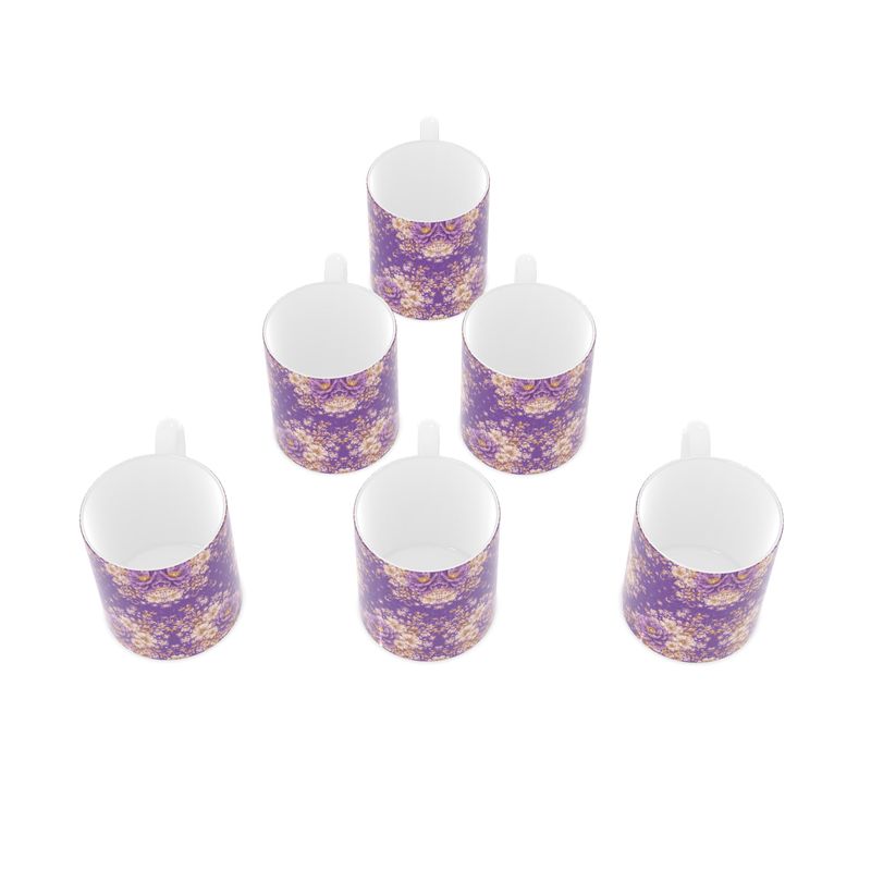 Set of six small purple and gold floral mugs on a white background