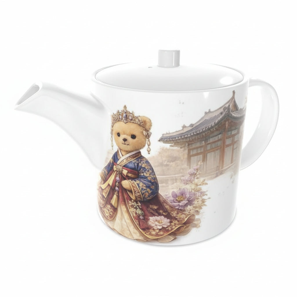 Teapot with a teddy bear in traditional attire and a scenic design on a white background