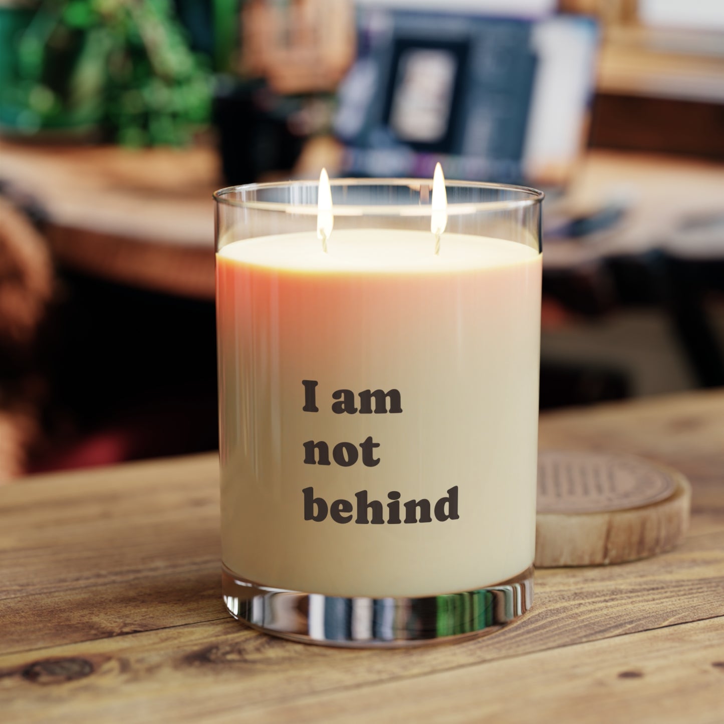 Soft Life Society Affirmation Candle with 'I am not behind' text on a wooden surface