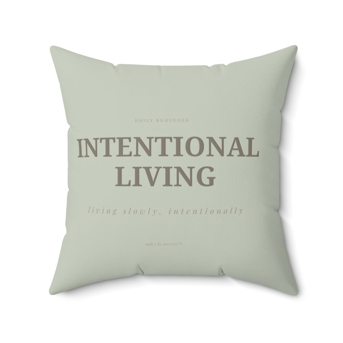 Light green pillow with 'Intentional Living' text on a white background