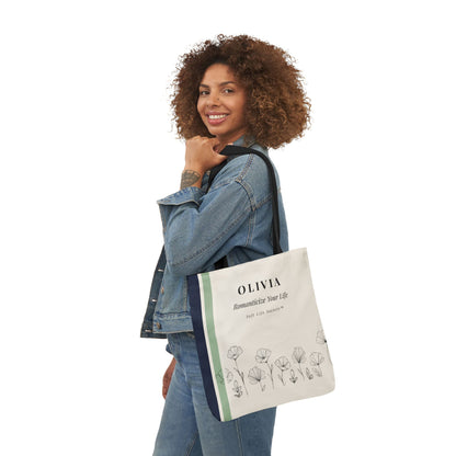 Woman holding a tote bag with 'OLIVIA' branding on a white background