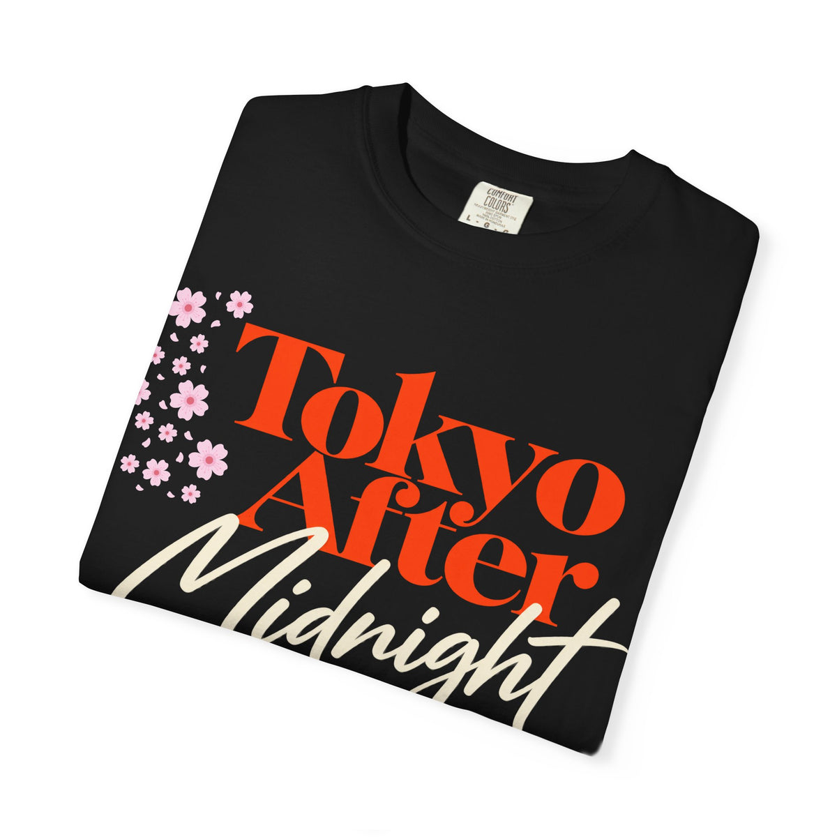 Close-up of Tokyo After Midnight tee graphic with orange and cream typography and cherry blossoms