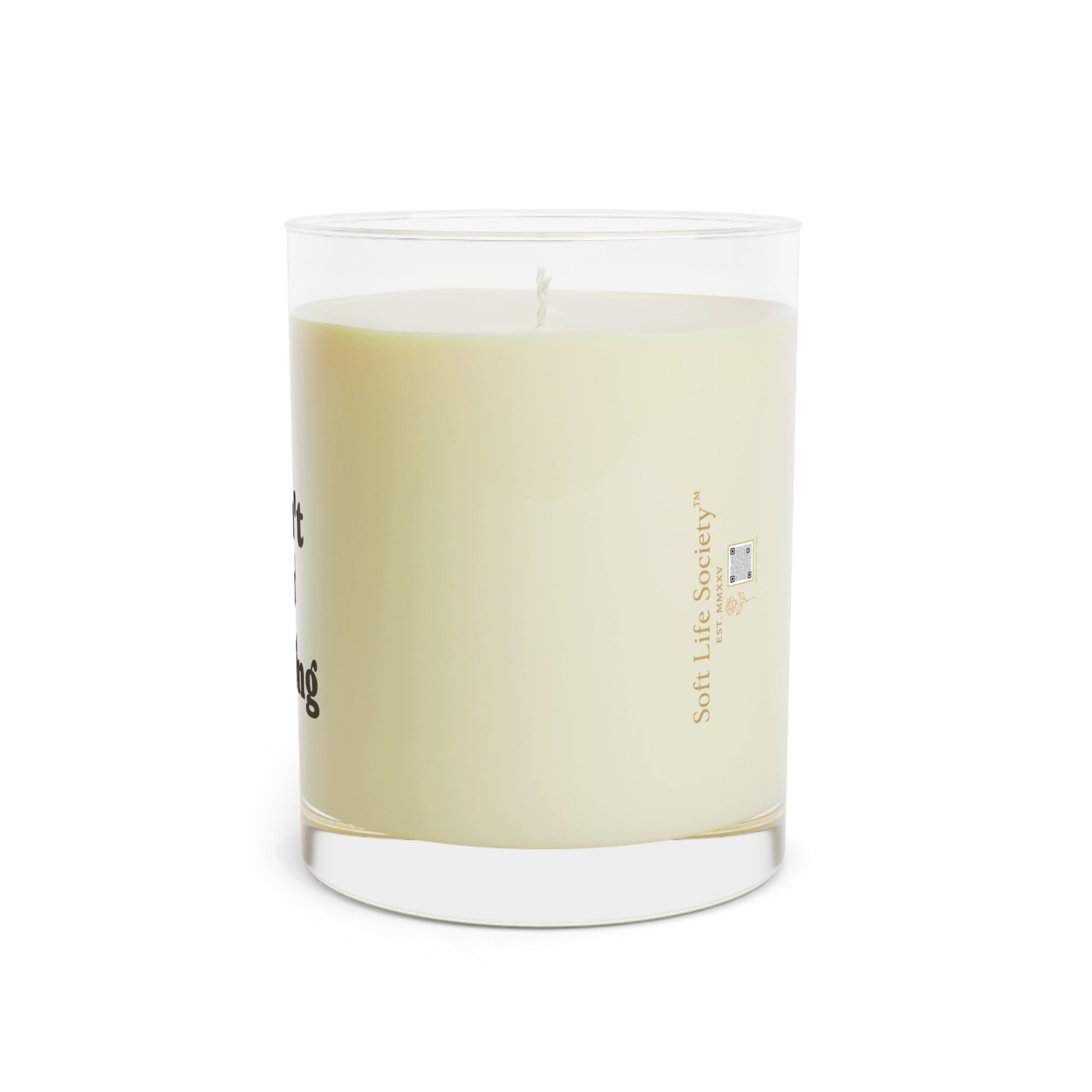 Scented candle in a glass jar with a label on a white background