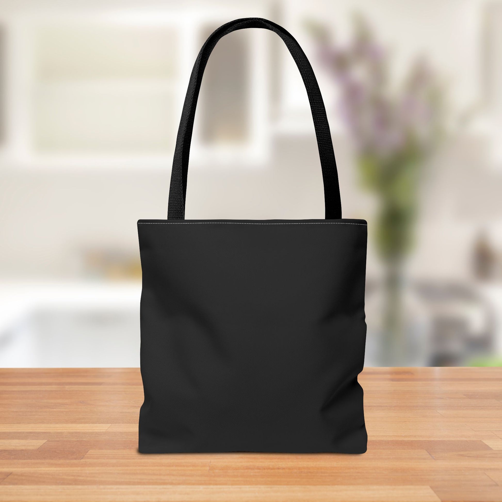 Back view of Black tote bag featuring a vintage witch design with the text "Broomsticks - The Original Eco-Friendly Ride" in red and white. Perfect for Halloween or everyday use.