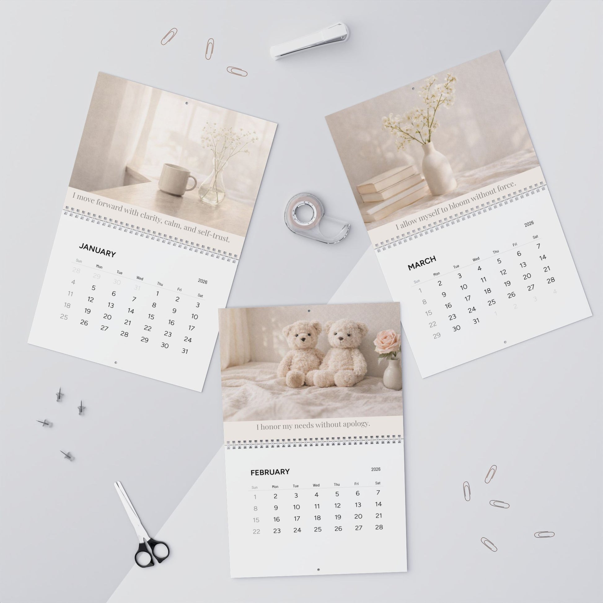 Three calendar pages showing January, February, and March on a light gray surface with stationery items.