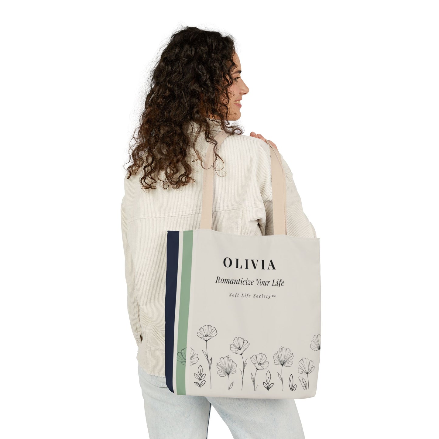 Woman holding a tote bag with floral design and text on a white background
