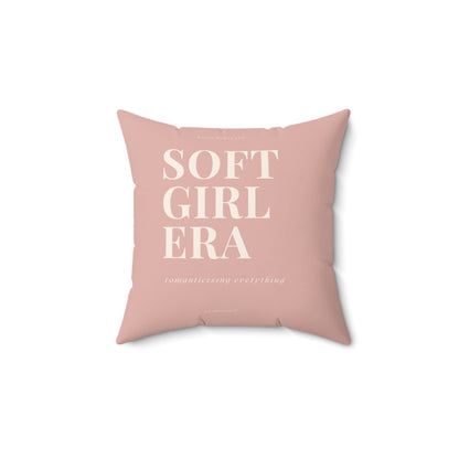 Pink pillow with 'SOFT GIRL ERA' text on a white background