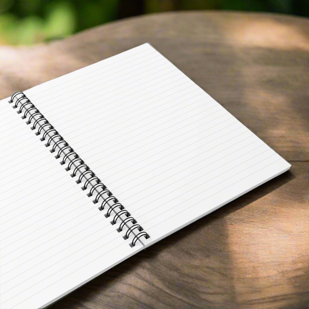 Close-up of the open lined white pages of notebook with vibrant floral and cosmic design.