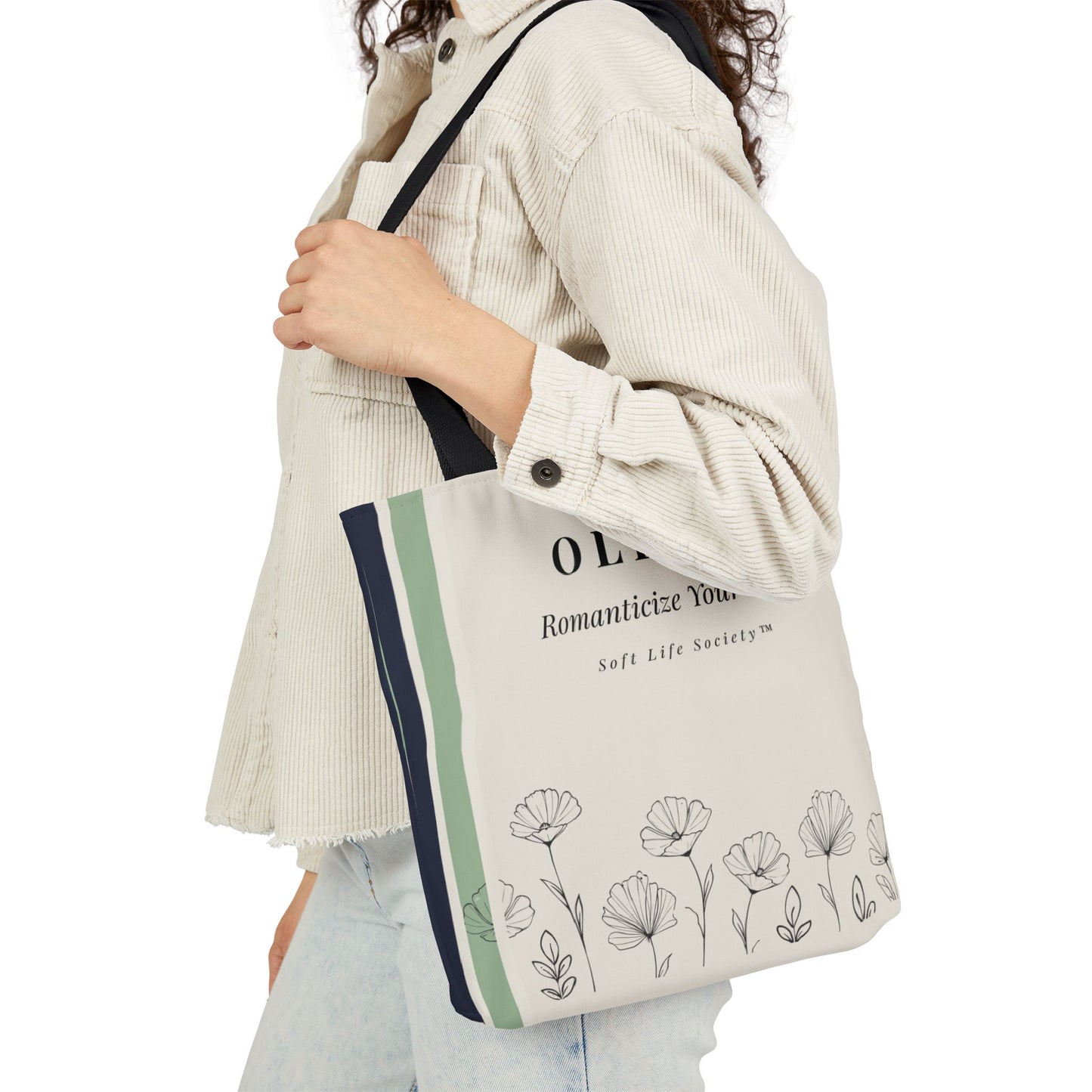 Person holding a tote bag with floral design and text on a white background
