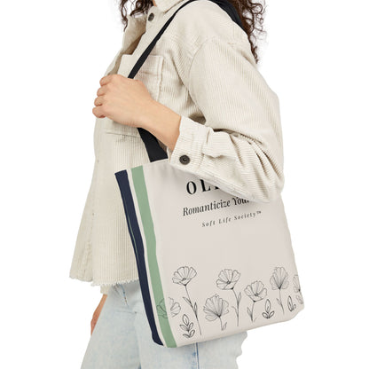 Person holding a tote bag with floral design and text on a white background