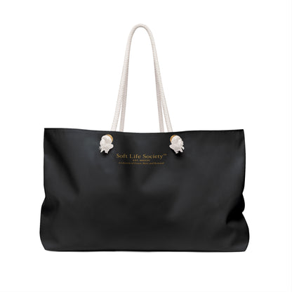 Back side of the Soft Life Girlie weekender tote featuring small Soft Life Society gold micro-branding and white rope handles.