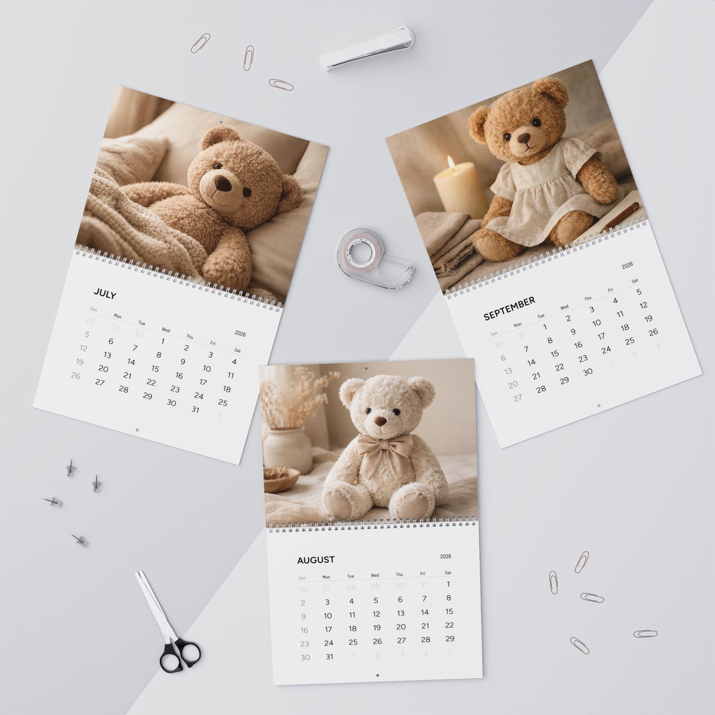 Calendar with teddy bear images on a light gray surface with office supplies.