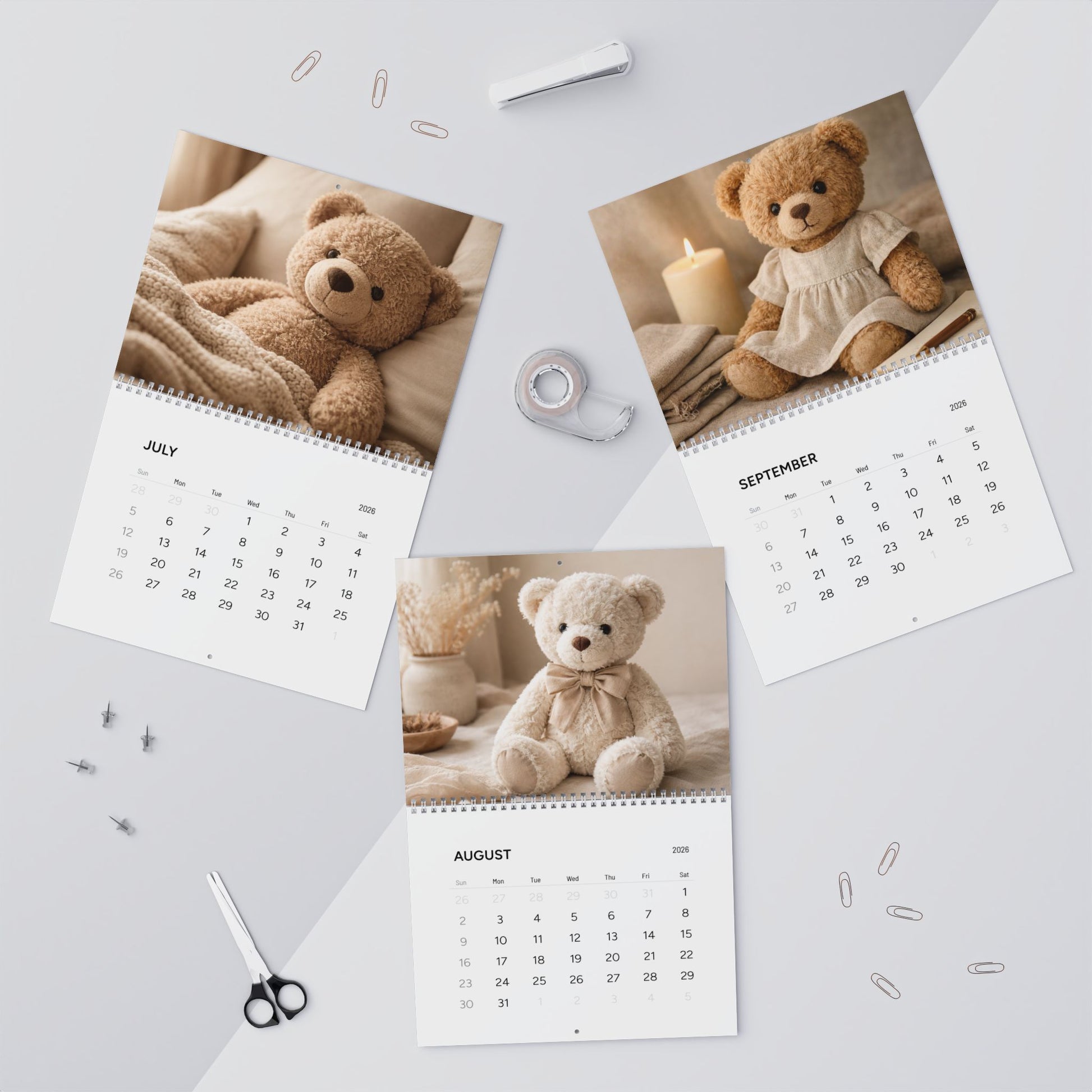 Calendar with teddy bear images on a light gray surface with office supplies.