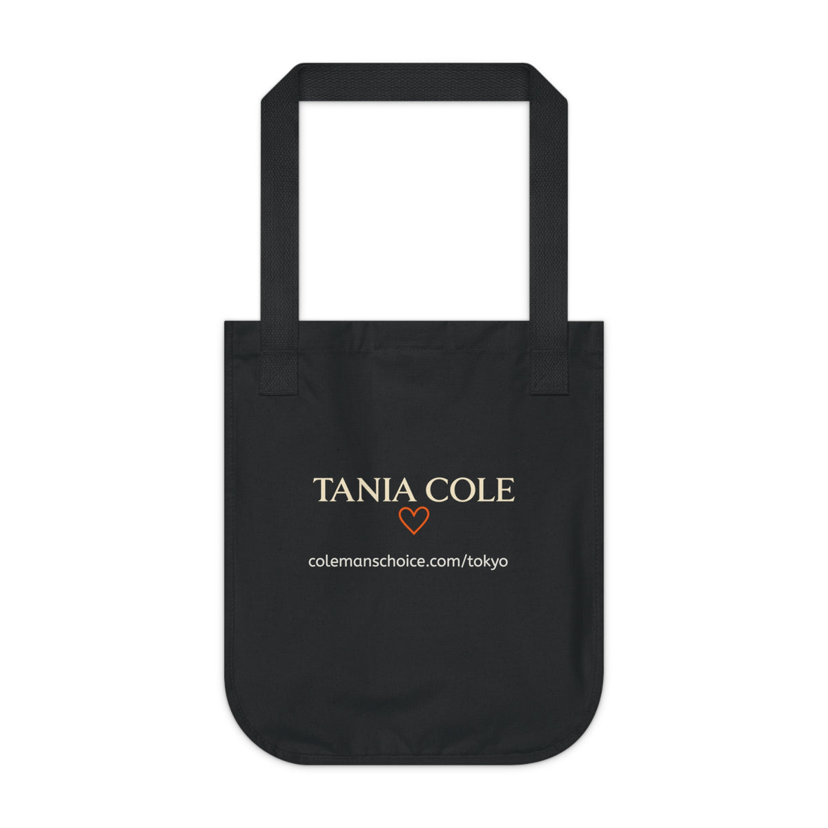 Back view of the Tokyo After Midnight black organic cotton tote featuring Tania Cole branding and collection website.