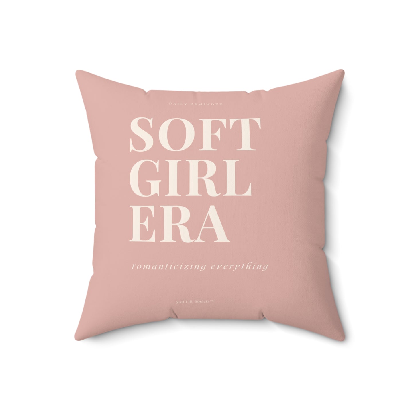 Pink pillow with 'SOFT GIRL ERA' text on a white background