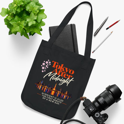 Tokyo After Midnight black reader tote bag styled with a notebook, camera, and desk accessories.