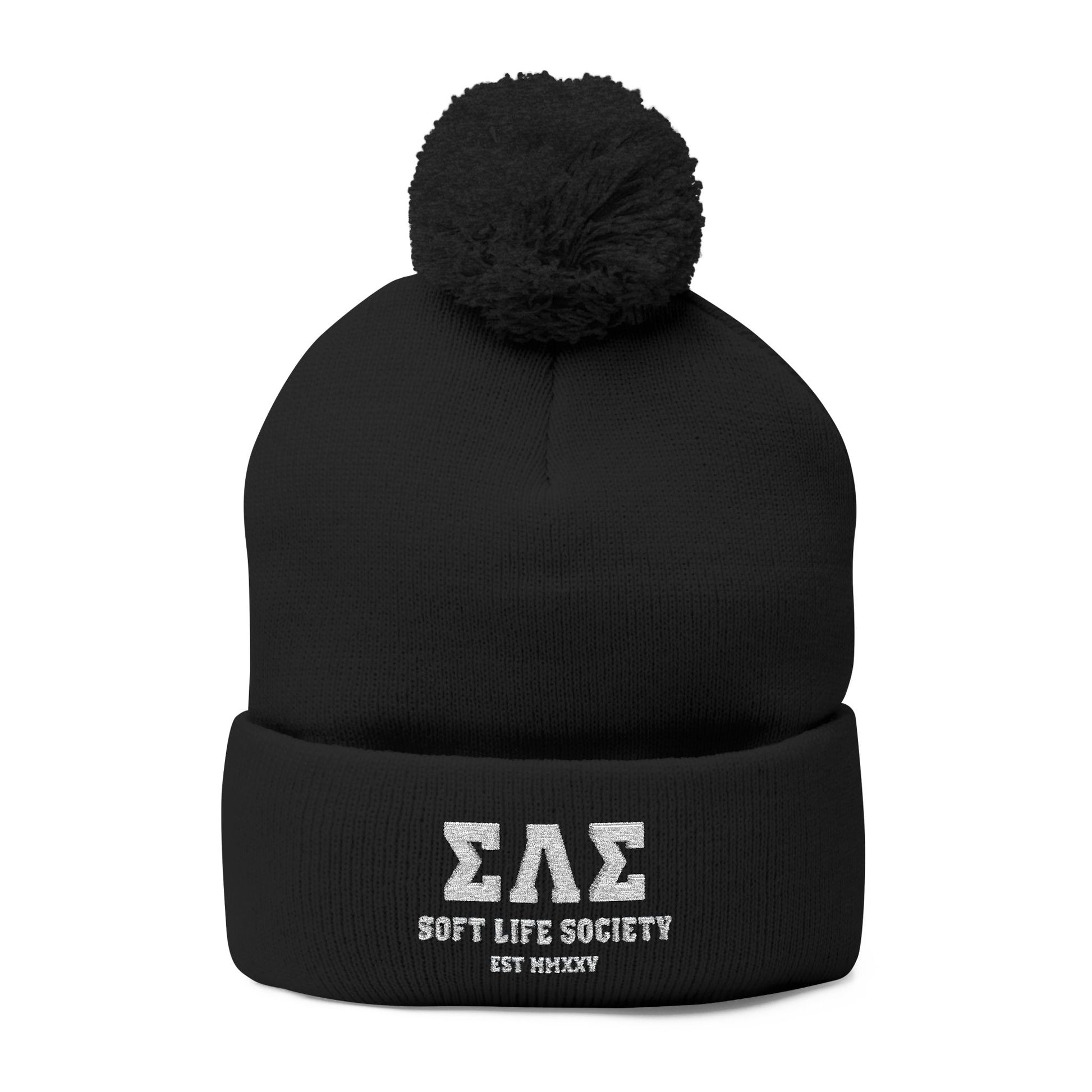 Black beanie with pom-pom and embroidered text on a white background