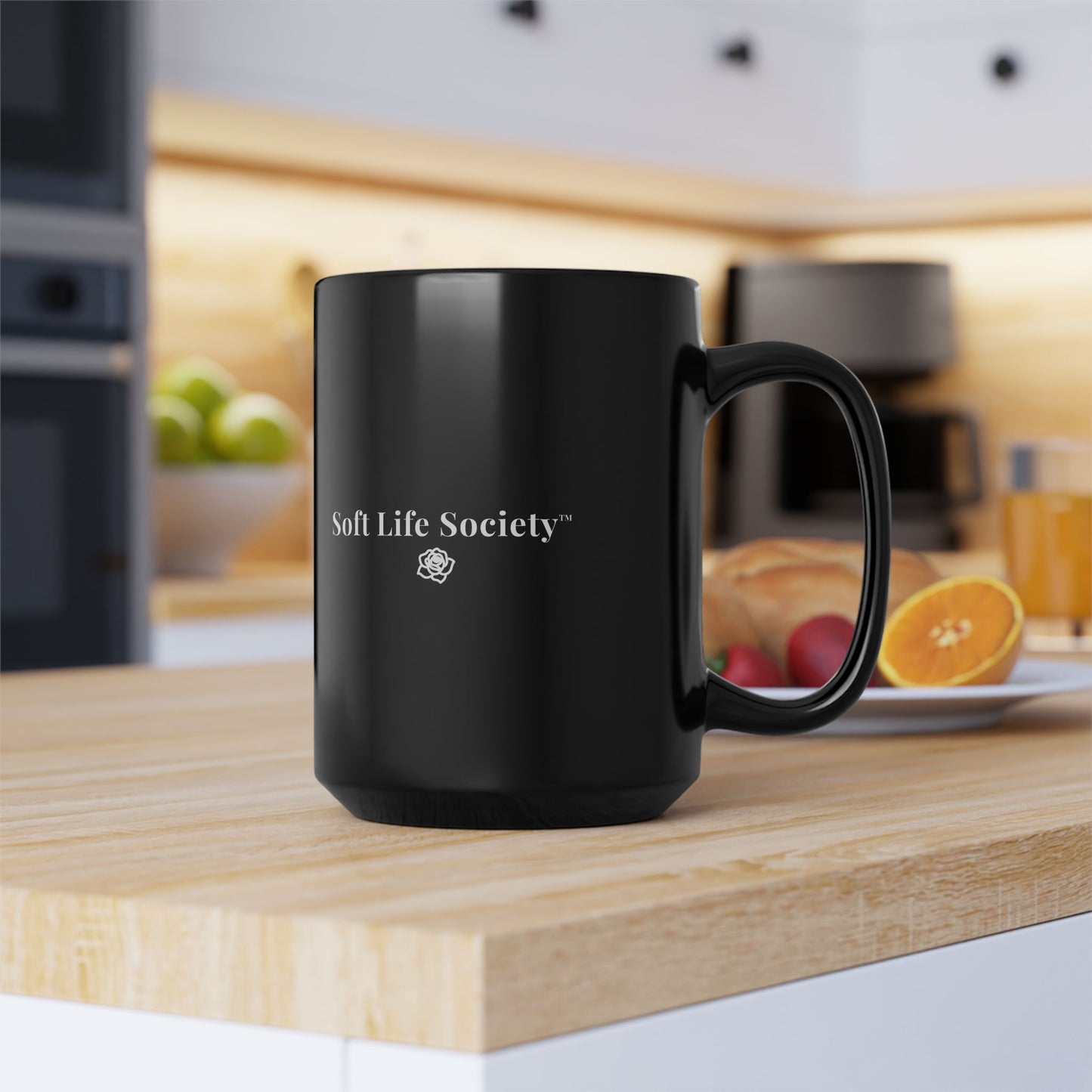 15 oz Black mug with 'Soft Life Society' logo on a kitchen counter