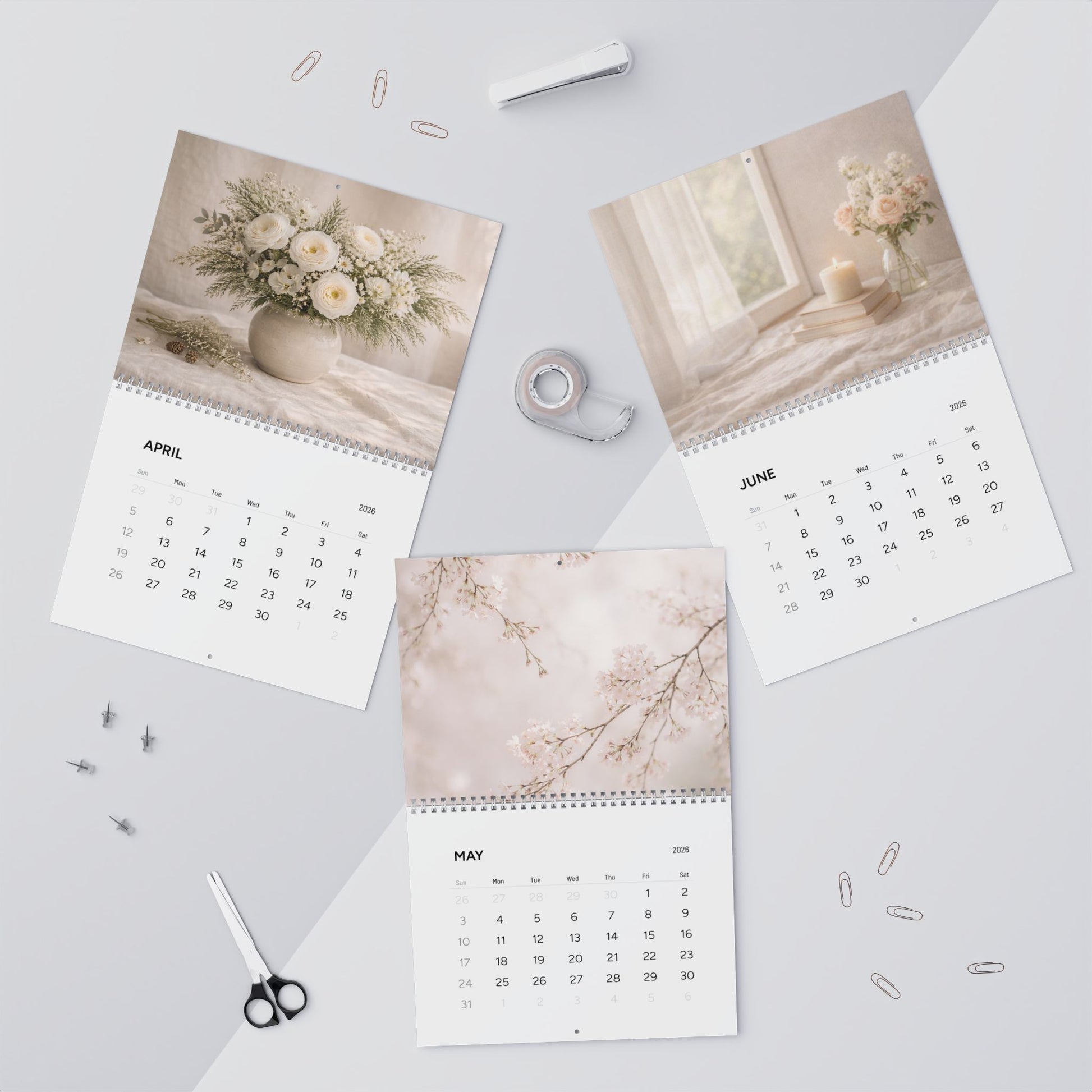 Calendar with floral and nature-themed pages on a light gray surface.