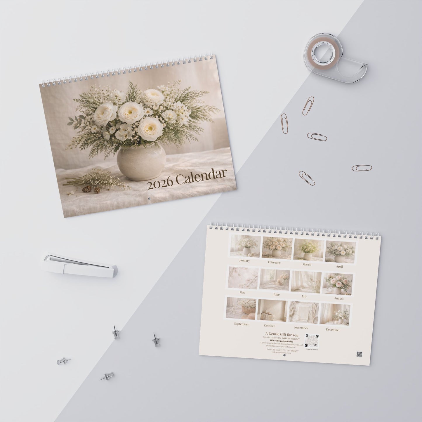 2026 calendar with floral design on a light surface with office supplies.