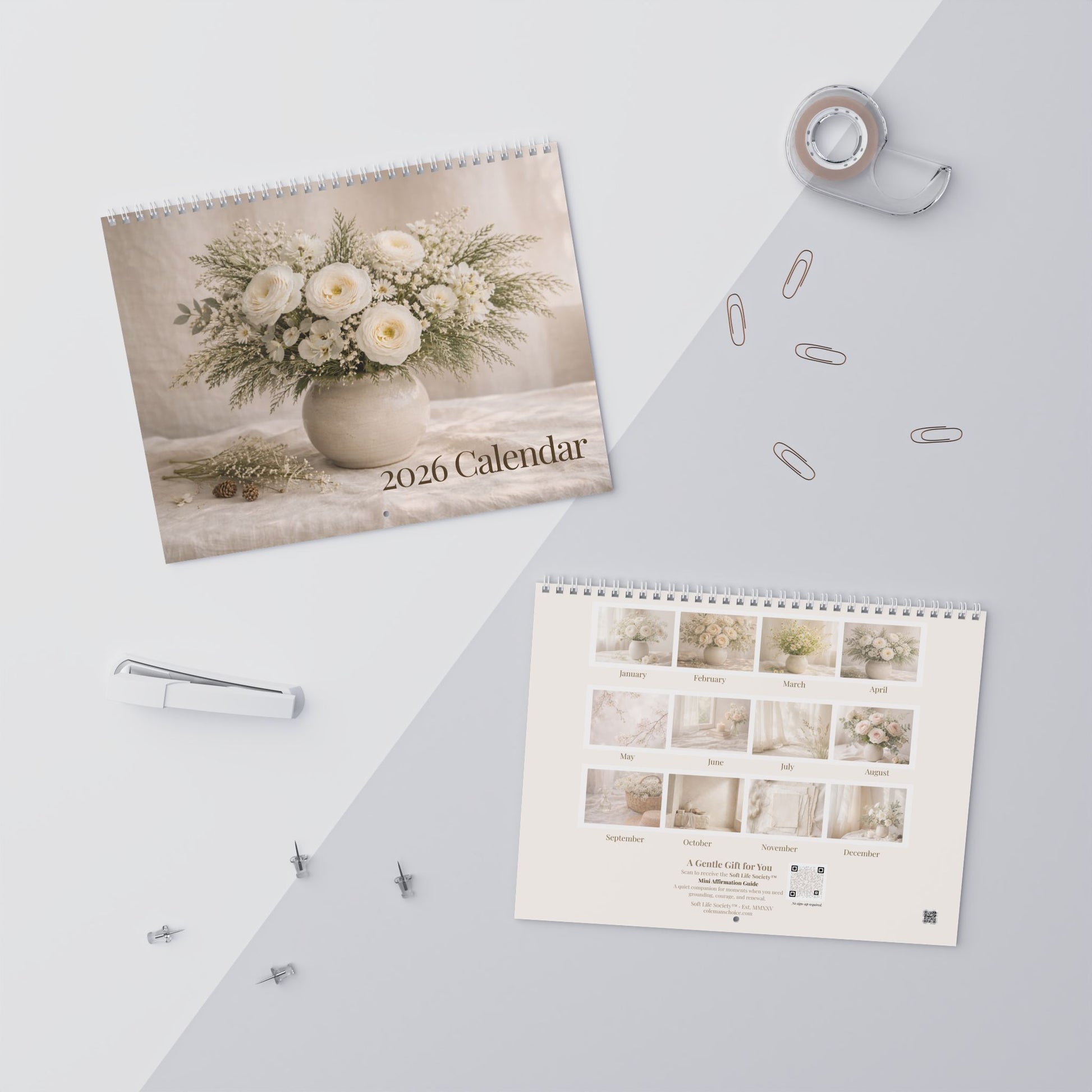 2026 calendar with floral design on a light surface with office supplies.