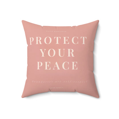 Pink pillow with 'PROTECT YOUR PEACE' text on a white background