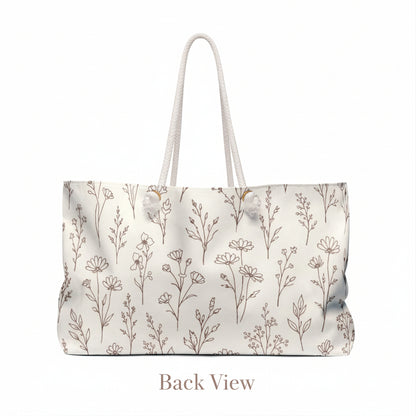Back view of neutral botanical floral canvas weekender bag with rope handles on clean studio background