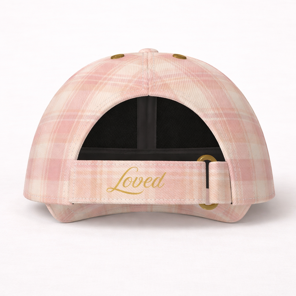 Pink plaid cap with 'Loved' embroidery on a white background