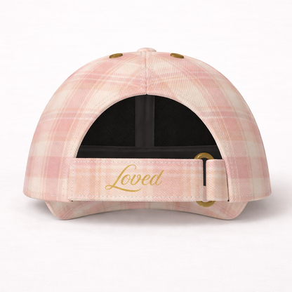 Pink plaid cap with 'Loved' embroidery on a white background