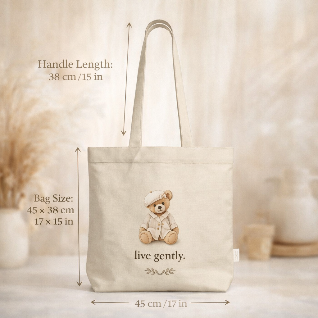 Beige tote bag with teddy bear design and measurements on a neutral background