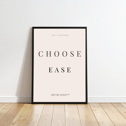 Framed poster with 'CHOOSE EASE' text on a white wall.