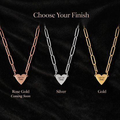 Three necklaces in rose gold, silver, and gold with heart pendants on a black background.