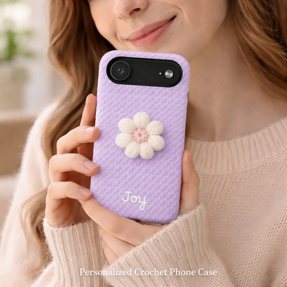 Person holding a purple phone case with a flower design and 'Joy' text.