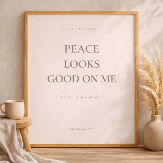 Framed artwork with motivational quote on a neutral background with decor items.