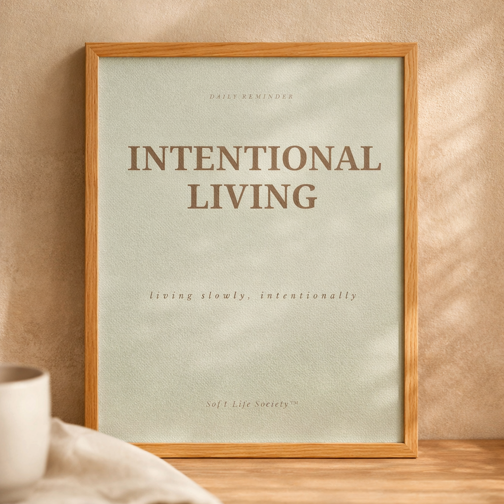 Framed poster with 'Intentional Living' text on a beige wall.