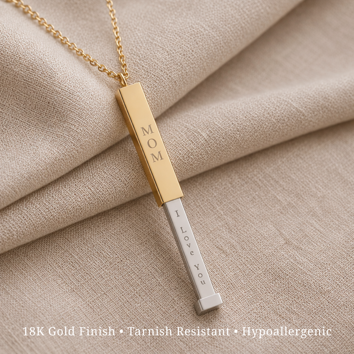 Mother's Day personalized gift ft. gold and silver necklace bar with 'MOM' and 'I LOVE YOU' text on beige fabric.