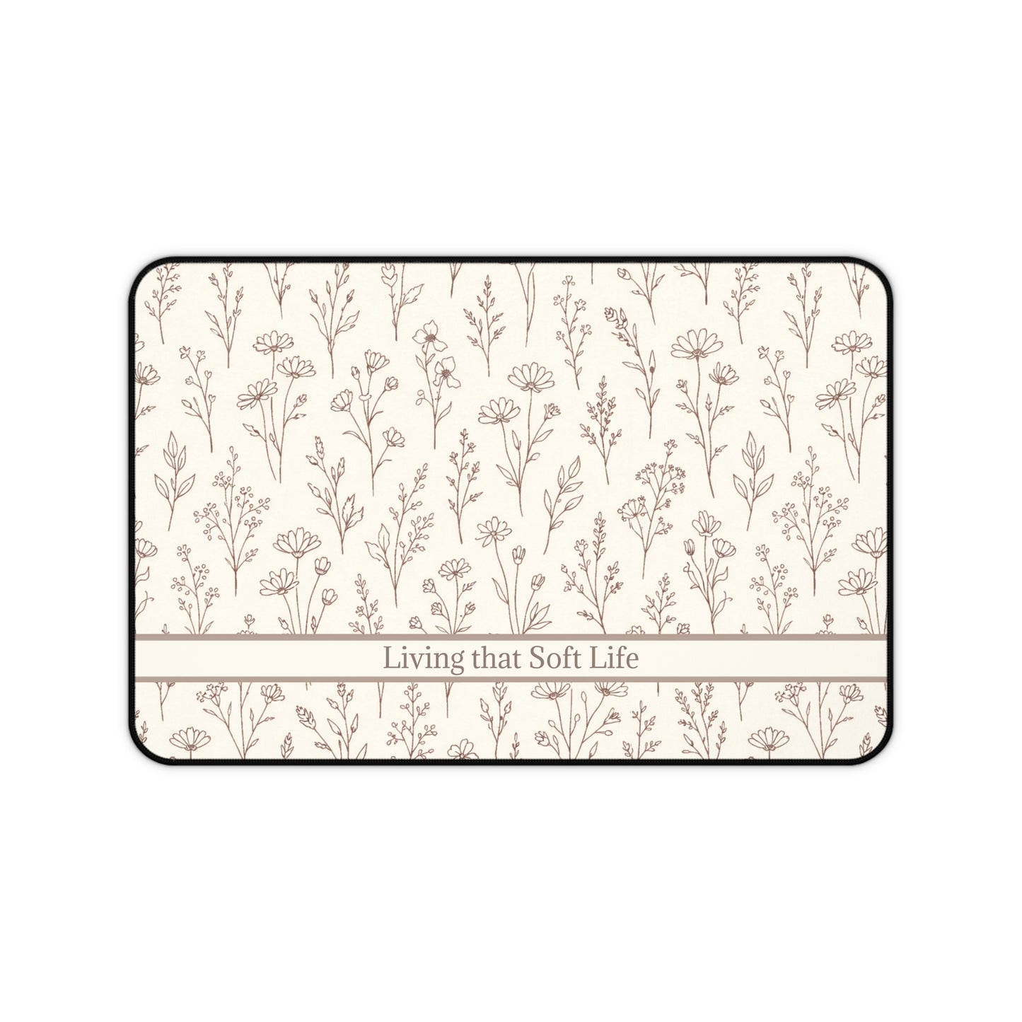 Desk mat with floral pattern and 'Living that Soft Life' text on a white background