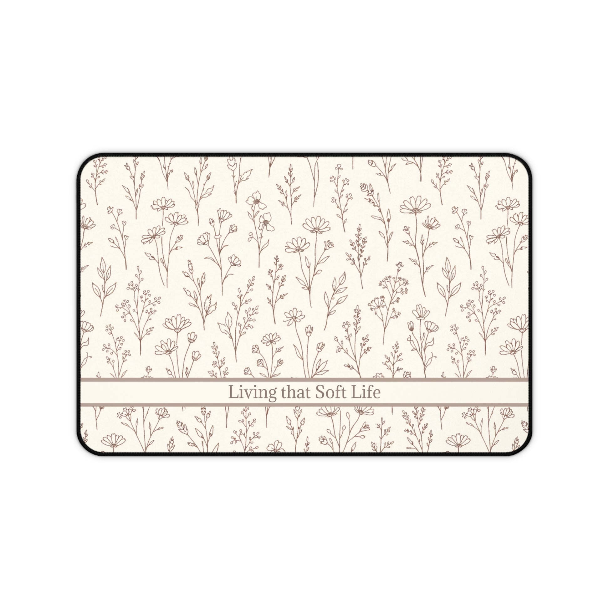 Desk mat with floral pattern and 'Living that Soft Life' text on a white background