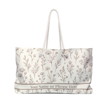 Floral patterned tote bag with customizable text on a white background