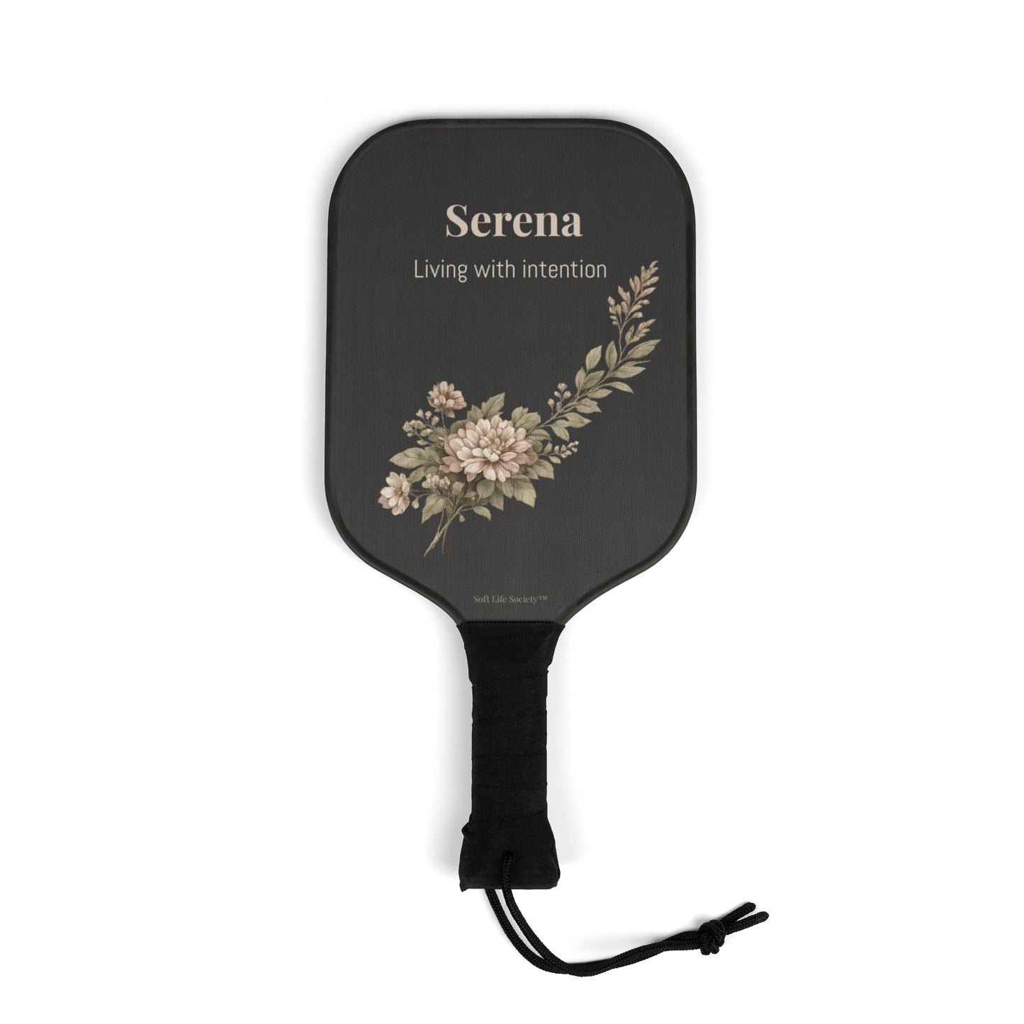 Black paddle with floral design and 'Serena' branding on a white background